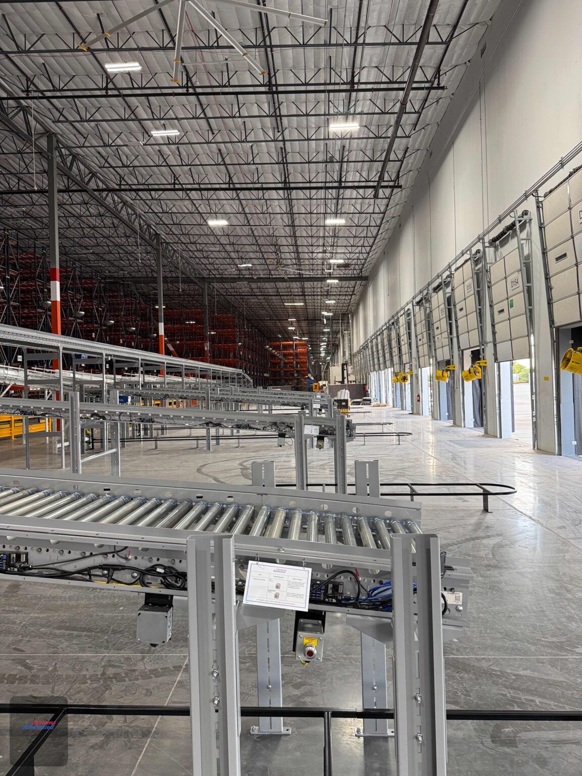 long, sweeping case-conveyor runs across a big DC