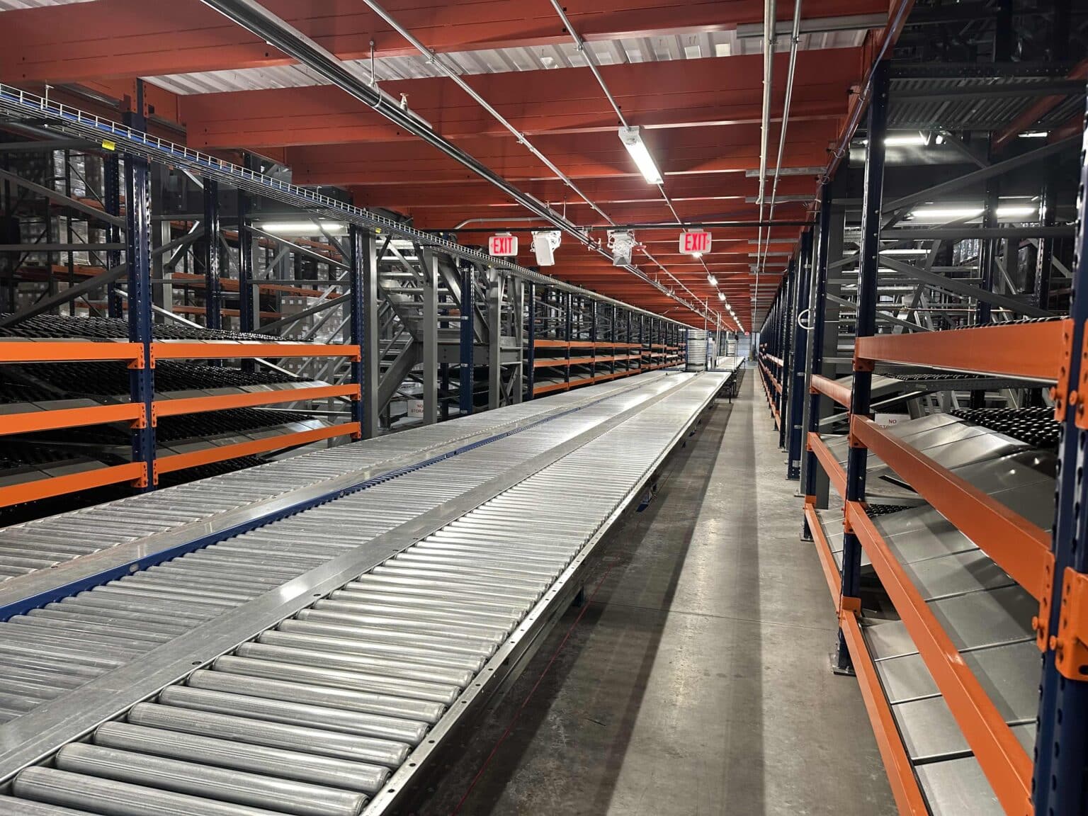 elevated conveyor alongside racking